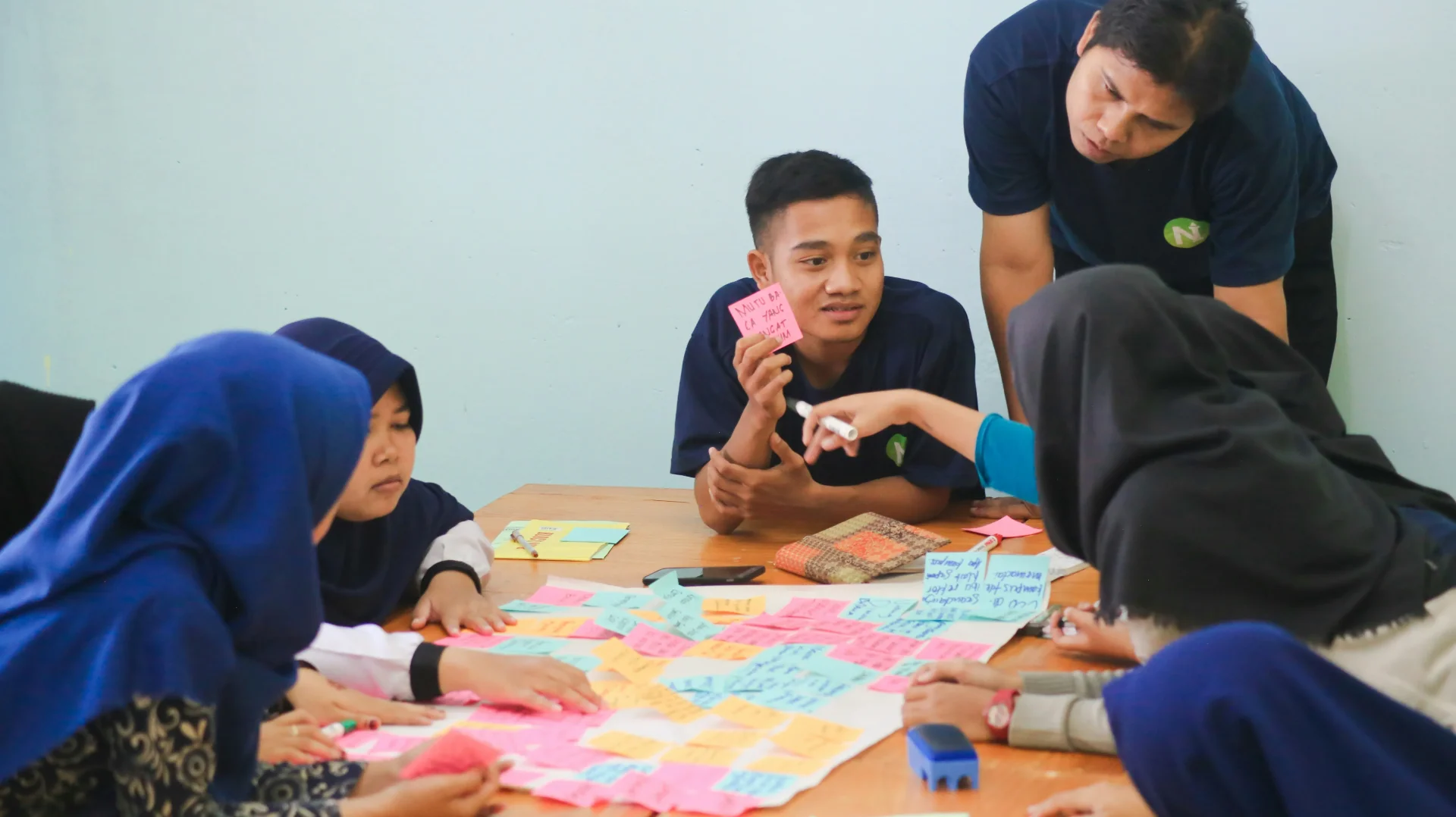 Team discussing educational materials